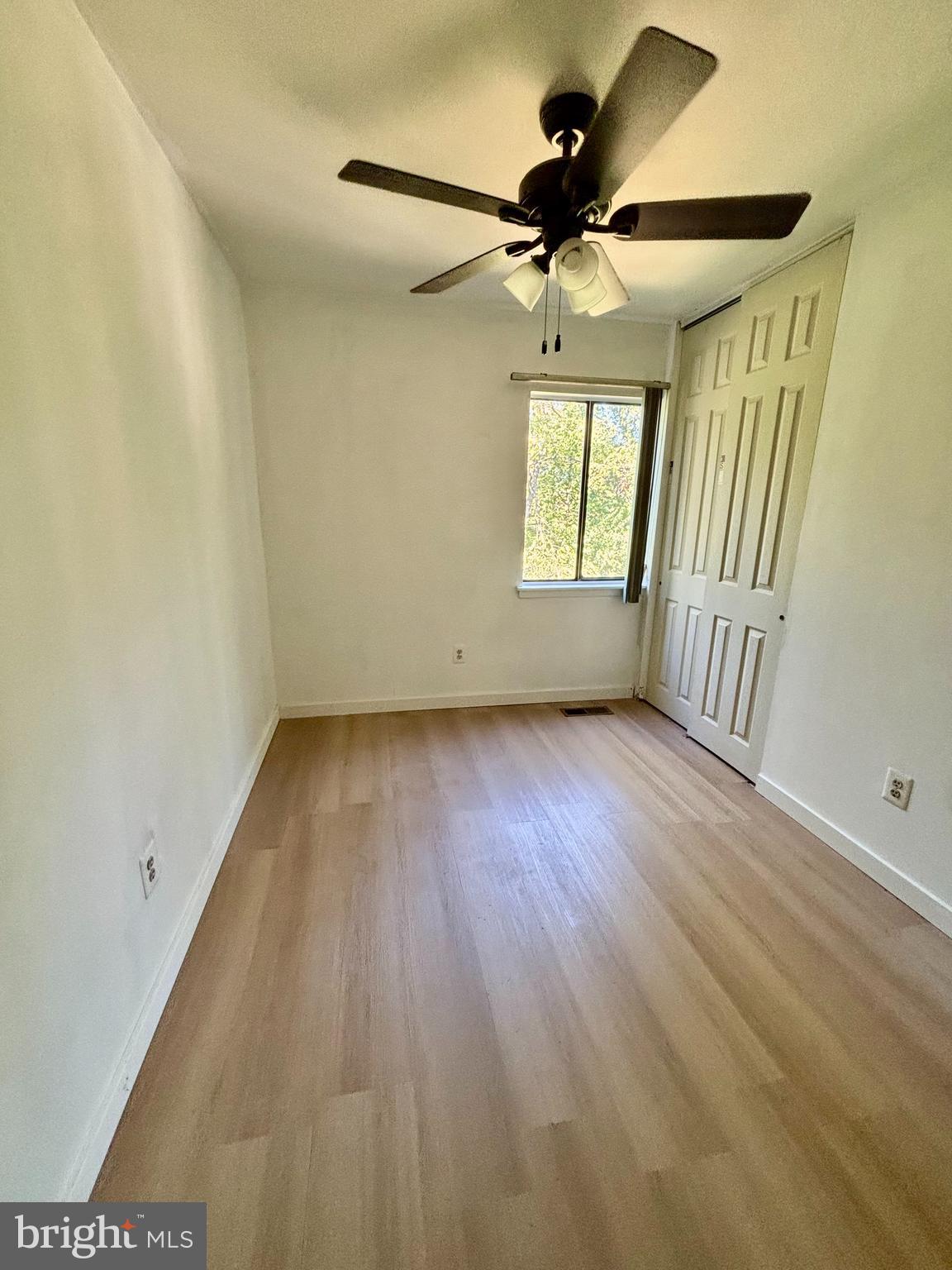 9336 Neil Road, Unit B Philadelphia, PA 19115 - Photo 21 of 37 an empty room with wooden floor fan and windows