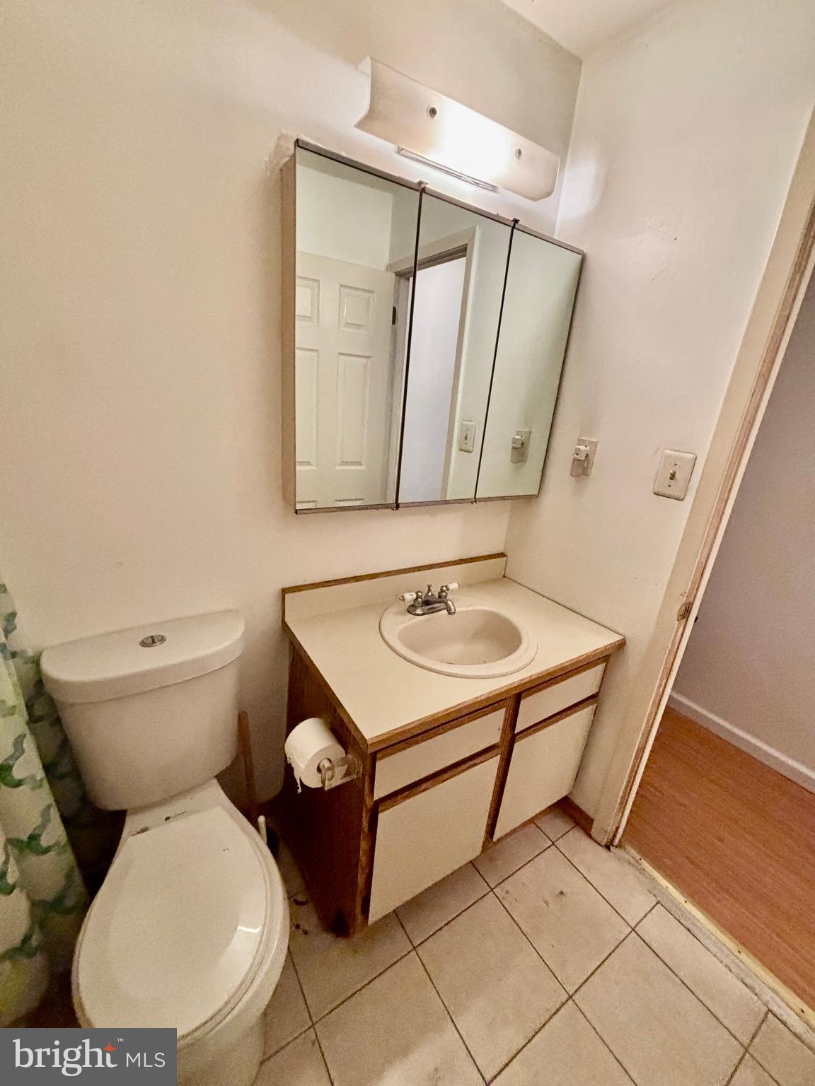 9336 Neil Road, Unit B Philadelphia, PA 19115 - Photo 24 of 37 a bathroom with a toilet a sink and a mirror