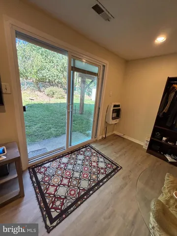 a view of an empty room and window with a rug