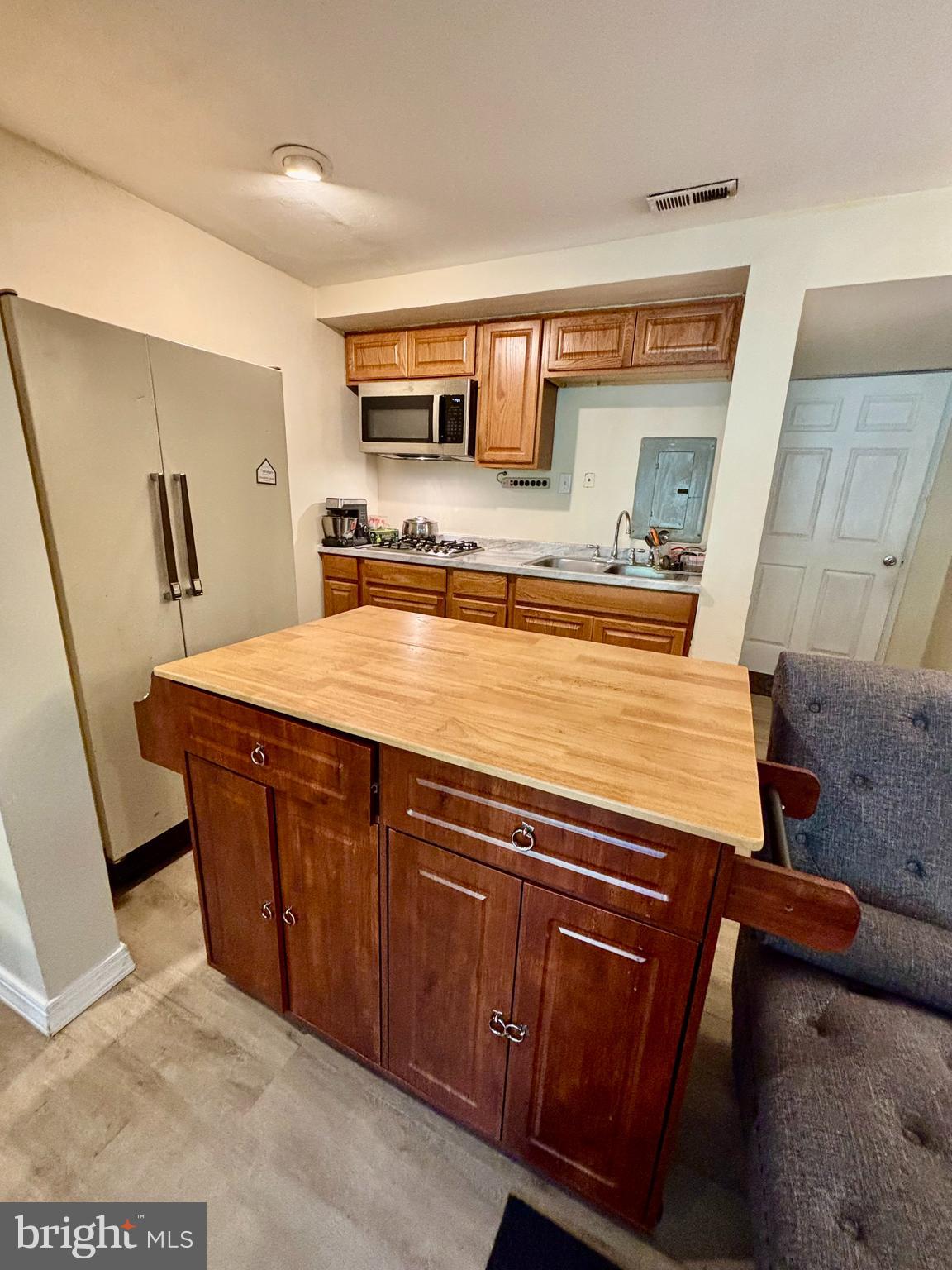 9336 Neil Road, Unit B Philadelphia, PA 19115 - Photo 29 of 37 a room with stainless steel appliances a sink a stove a microwave a refrigerator and cabinets