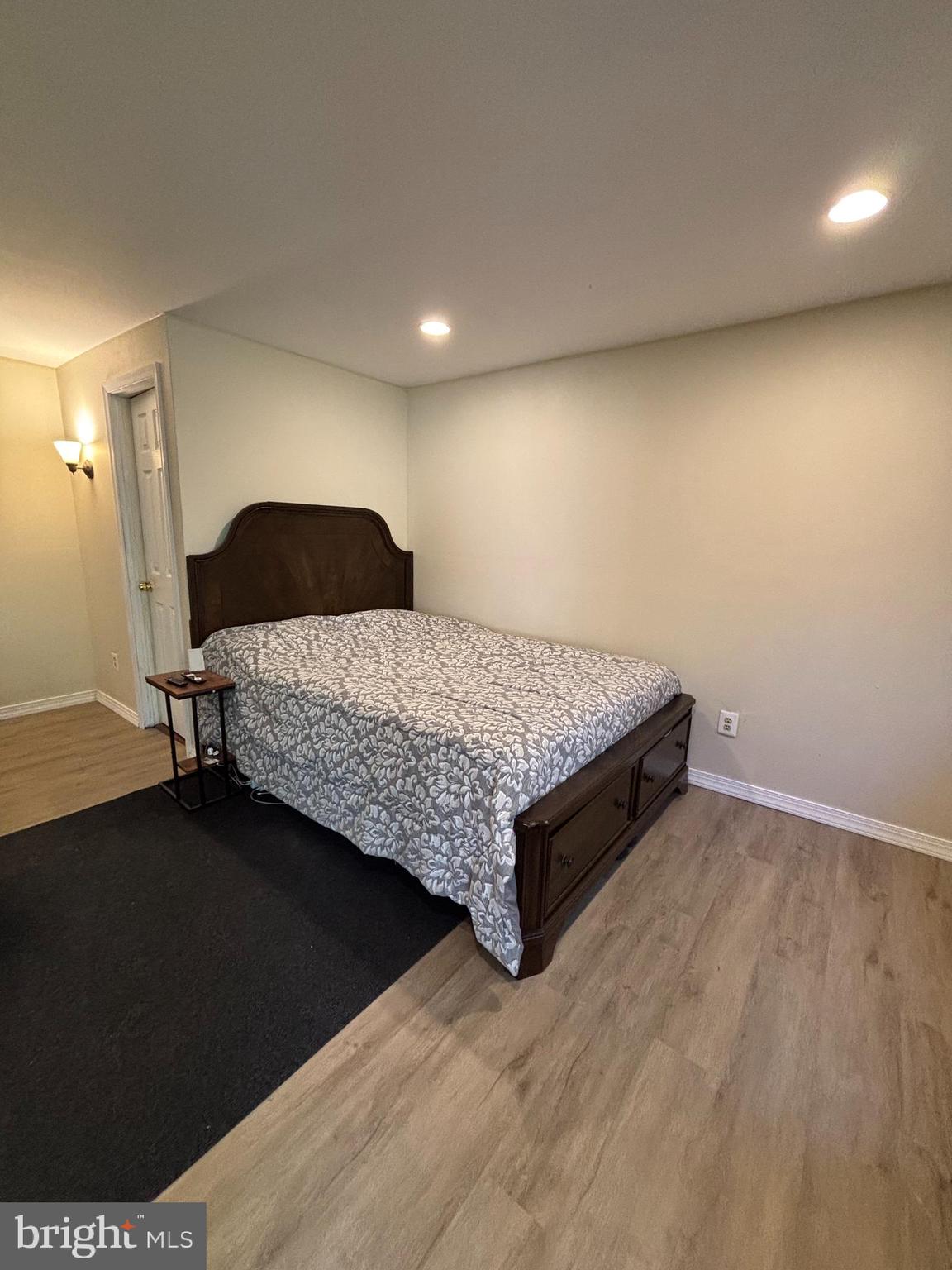 9336 Neil Road, Unit B Philadelphia, PA 19115 - Photo 31 of 37 a spacious bedroom with a bed and a table in it