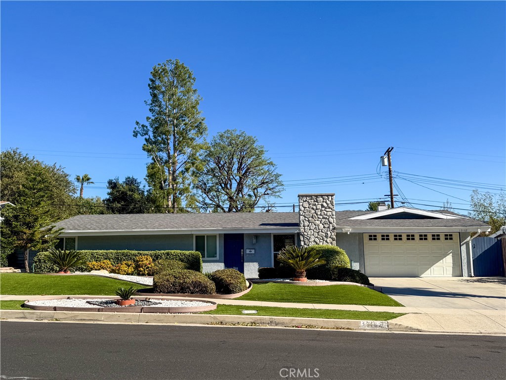 12162 Bradford Place Granada Hills, CA 91344 - Photo 1 of 27 a view of a house with a yard and potted plants