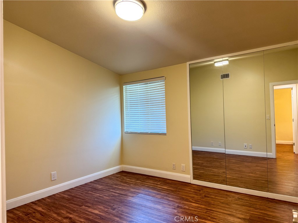 12162 Bradford Place Granada Hills, CA 91344 - Photo 12 of 27 a view of an empty room with wooden floor and a window