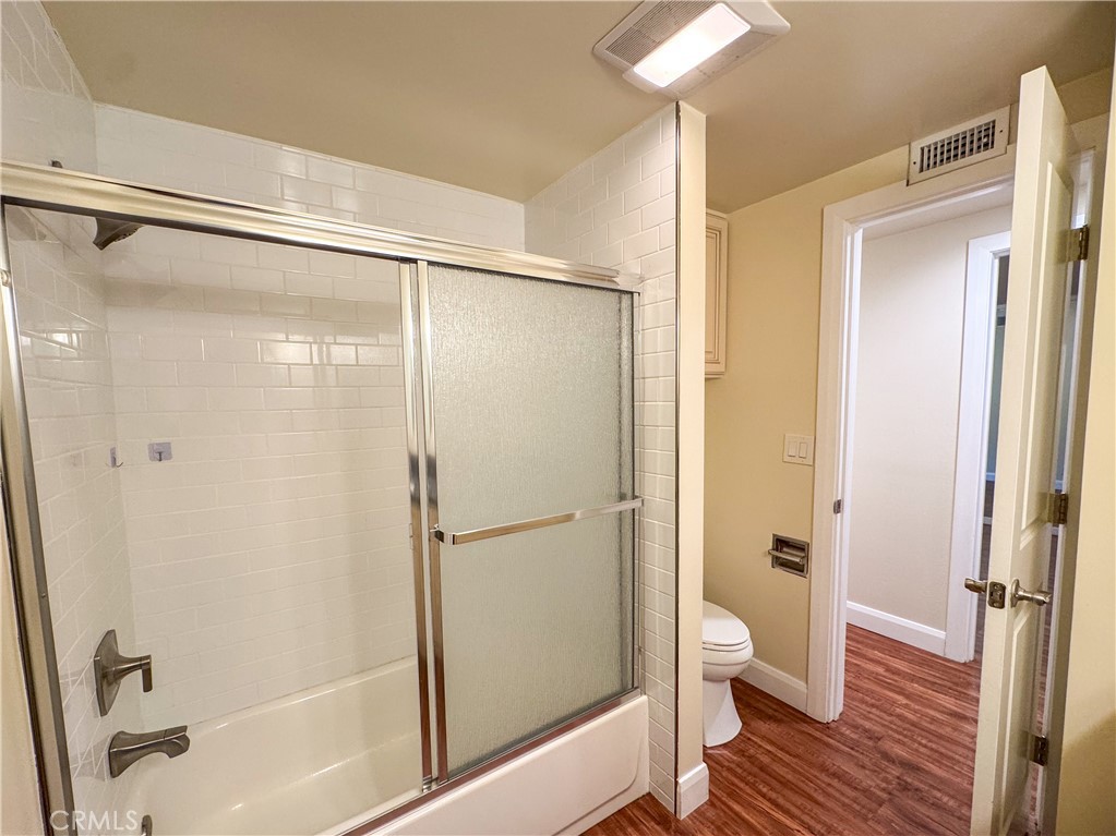 12162 Bradford Place Granada Hills, CA 91344 - Photo 13 of 27 a bathroom with a glass shower door