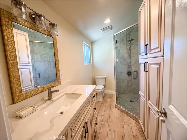 a bathroom with a sink mirror and shower