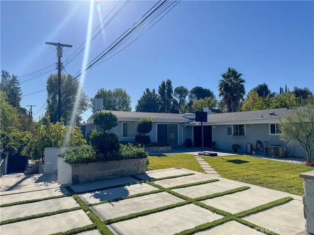 a view of a house with swimming pool and sitting area