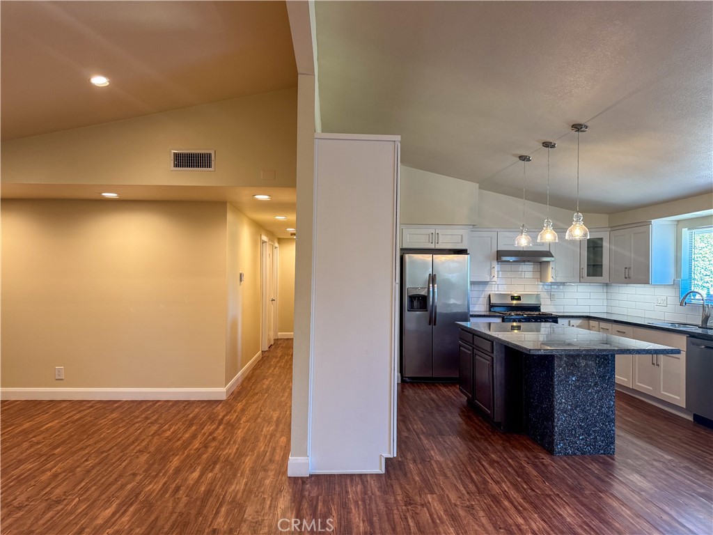12162 Bradford Place Granada Hills, CA 91344 - Photo 4 of 27 a kitchen with stainless steel appliances granite countertop a sink stove and refrigerator