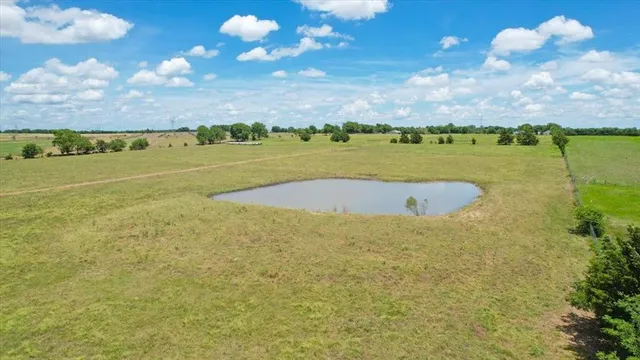 a view of a lake with houses in the background