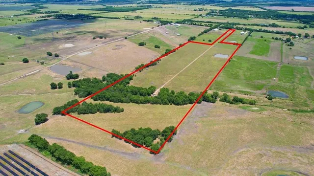 an aerial view of a tennis ground with large trees