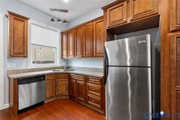 a kitchen with a refrigerator sink and cabinets