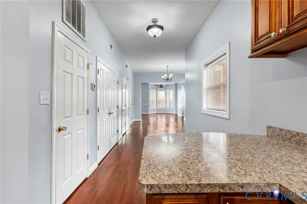 a view of a hallway to a bedroom and front door