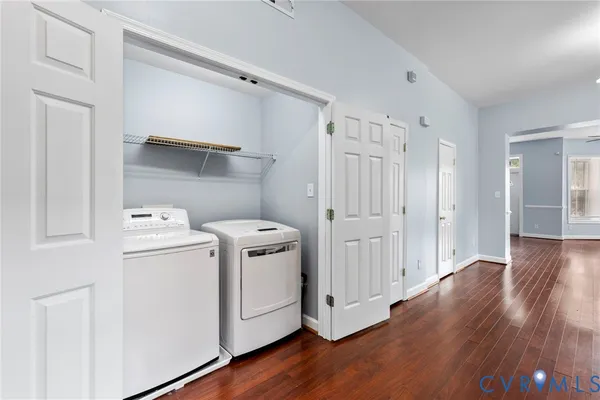 a view of a storage and utility room with wooden floor
