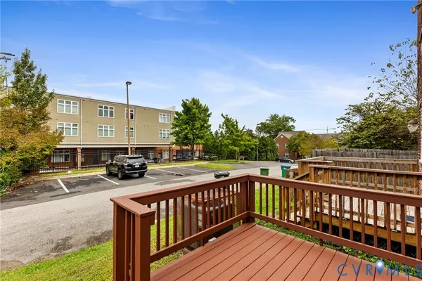 a view of a balcony with wooden floor and fence