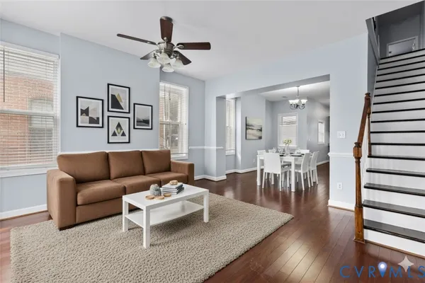 a living room with furniture and wooden floor