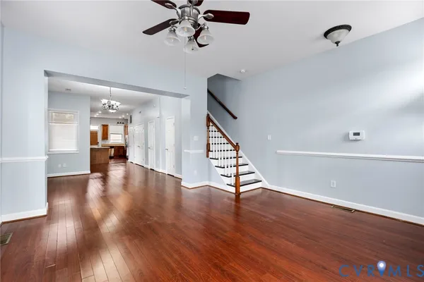 a view of a hallway with wooden floor and staircase