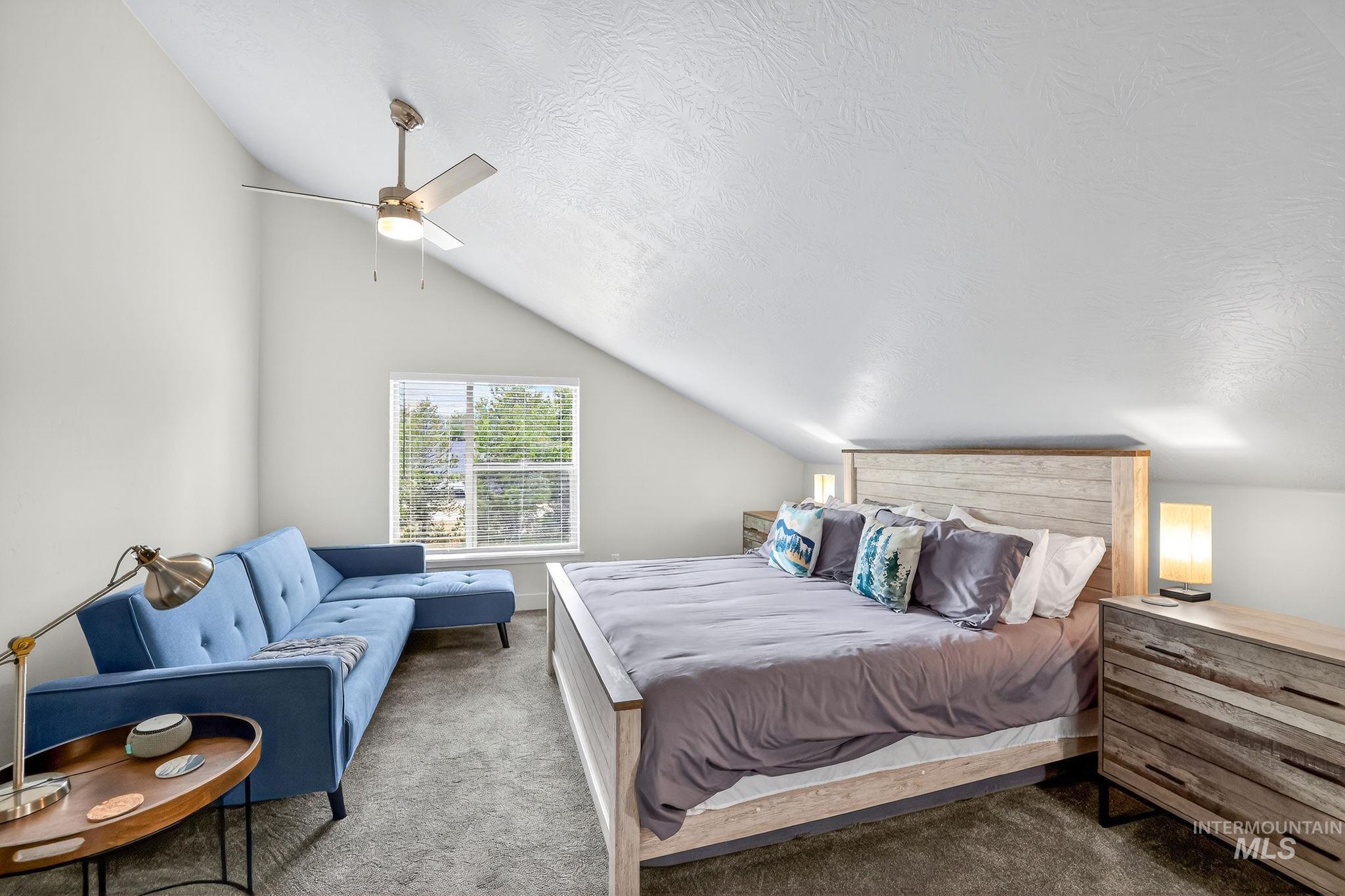 311 Broken Ridge Way McCall, ID 83638 - Photo 25 of 44 Attic bedroom featuring a sloped ceiling, recessed window with blinds, and a built-in ceiling fan with lighting