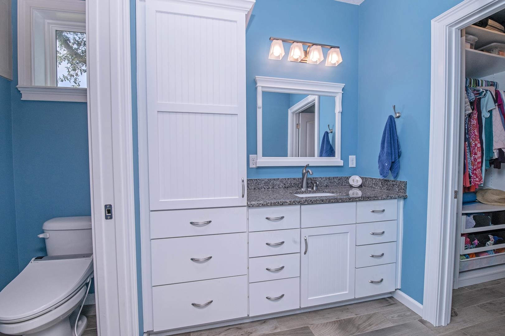 6056 Costanero Road St. Augustine, FL 32080 - Photo 14 of 30 a bathroom with a granite countertop toilet sink and mirror