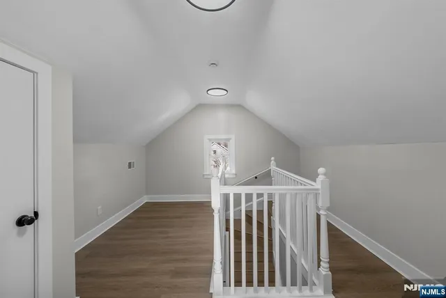 a view of a hallway with wooden floor and entryway