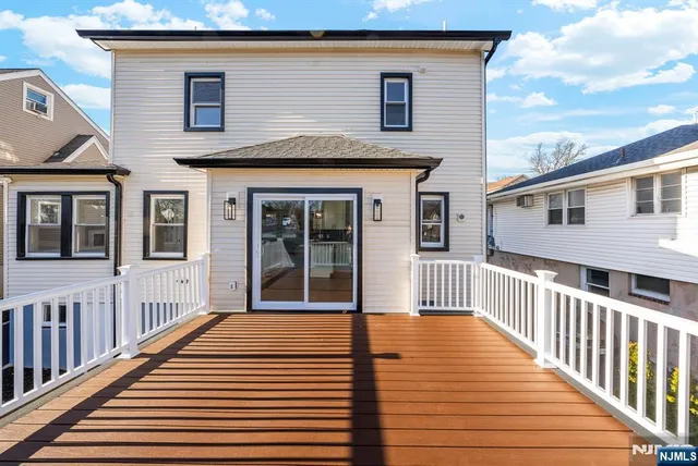 a view of a house with wooden deck