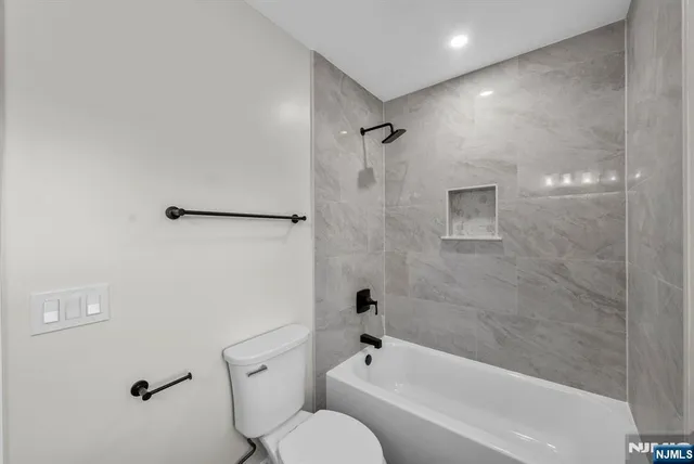 a bathroom with a bathtub and a shower