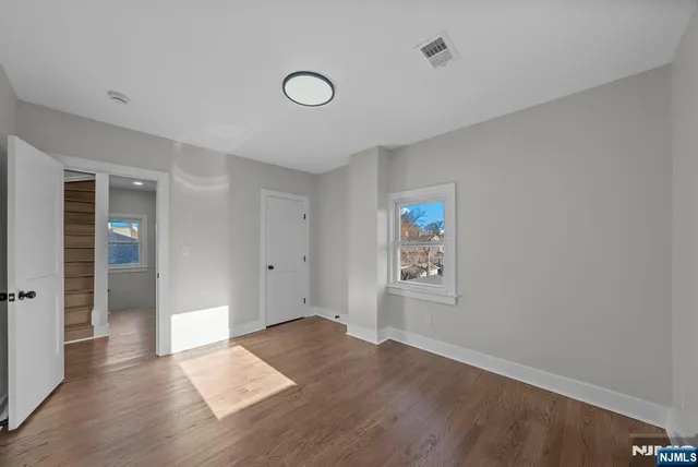 a view of wooden floor and windows in a room