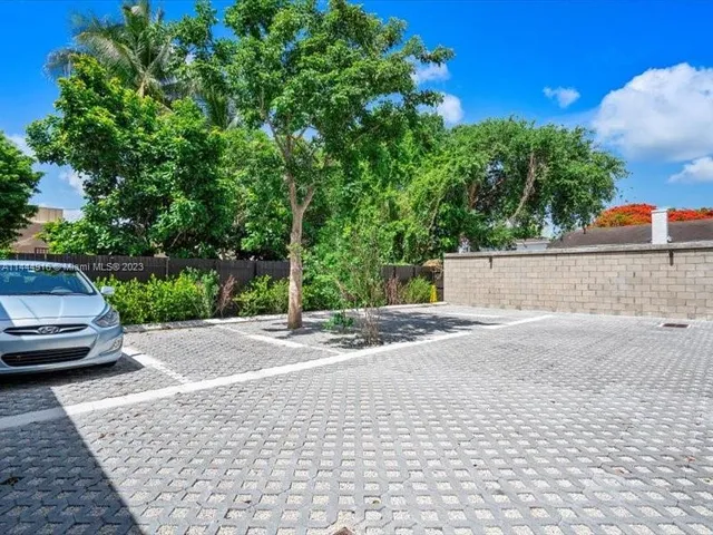 a view of a street with some cars parked on the road