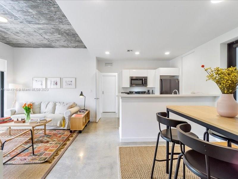 1053 Northwest 29th Street Miami, FL 33127 - Photo 17 of 38 a living room with furniture and kitchen view