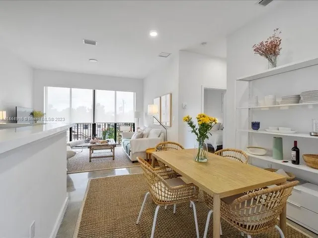 a dining room with furniture and wooden floor