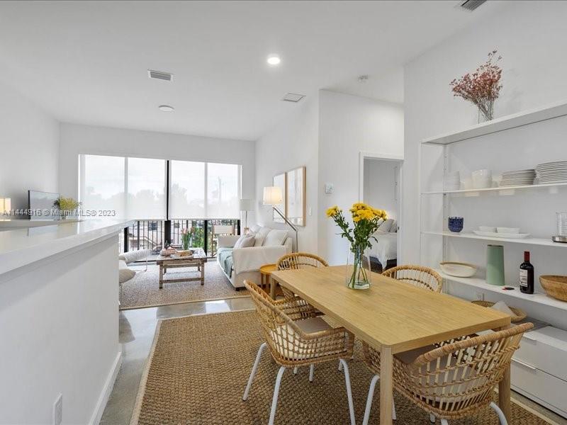 1053 Northwest 29th Street Miami, FL 33127 - Photo 18 of 38 a dining room with furniture and wooden floor