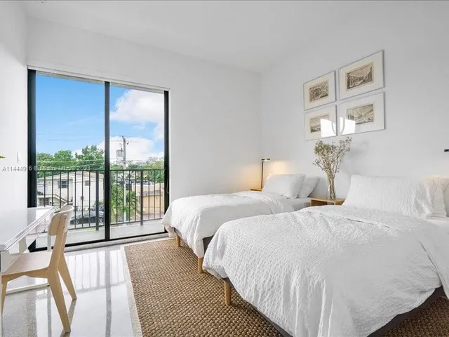 a bedroom with a large bed and a large window