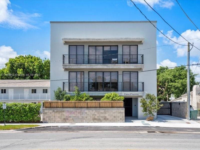 1053 Northwest 29th Street Miami, FL 33127 - Photo 2 of 38 a front view of a house with garden