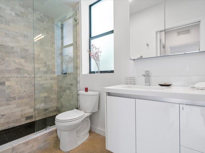 1053 Northwest 29th Street Miami, FL 33127 - Photo 29 of 38 a bathroom with a sink toilet and shower