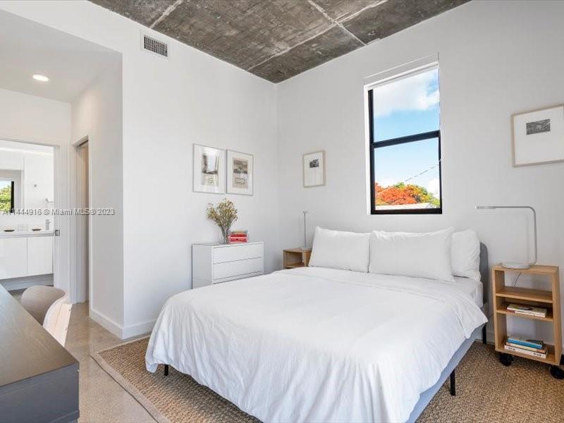 1053 Northwest 29th Street Miami, FL 33127 - Photo 30 of 38 a bedroom with a bed and a painting on the wall