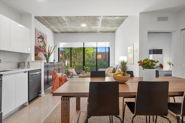 a view of a dining room with furniture large windows and wooden floor
