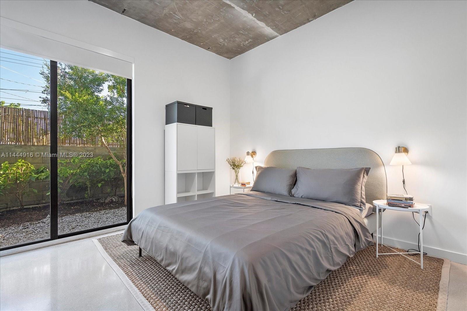 1053 Northwest 29th Street Miami, FL 33127 - Photo 36 of 38 a bedroom with a bed and a large window