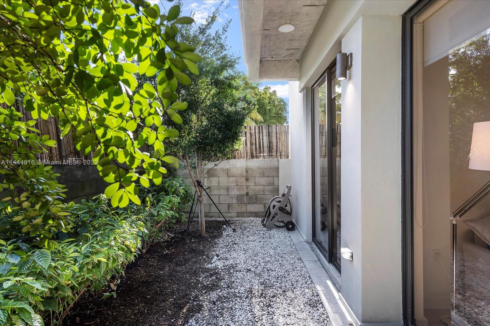1053 Northwest 29th Street Miami, FL 33127 - Photo 37 of 38 a view of a back yard from a corridor