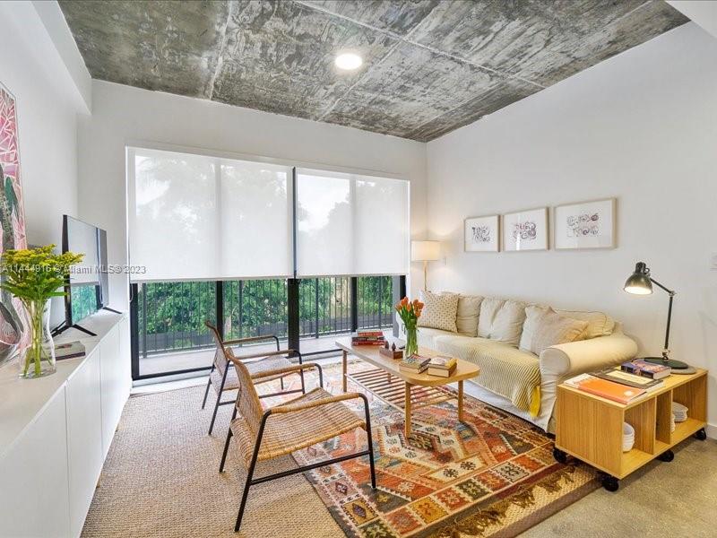 1053 Northwest 29th Street Miami, FL 33127 - Photo 6 of 38 a living room with furniture and a floor to ceiling window
