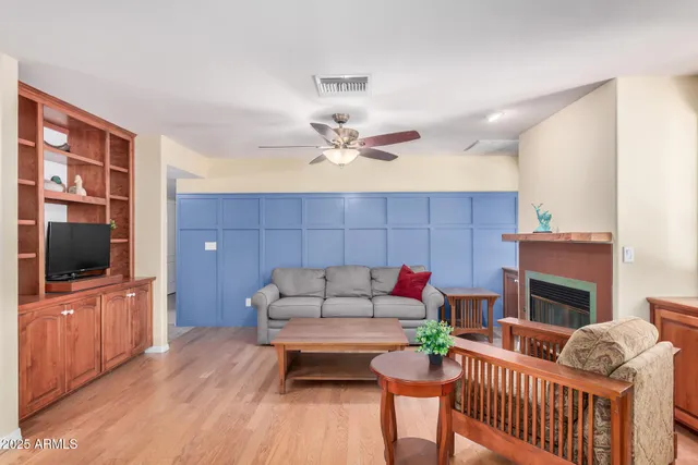 a living room with furniture a table and a fireplace