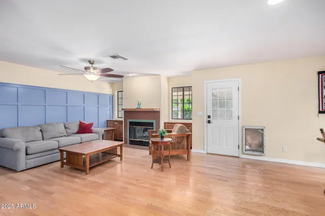 a living room with furniture a flat screen tv and a fireplace