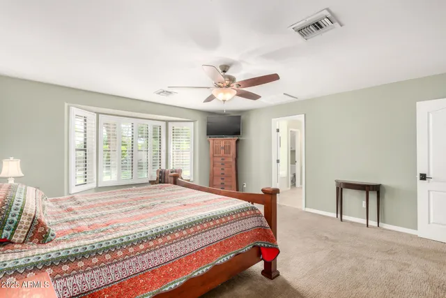 a bedroom with a bed couch and a window