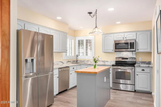 a kitchen with a sink stove and cabinets