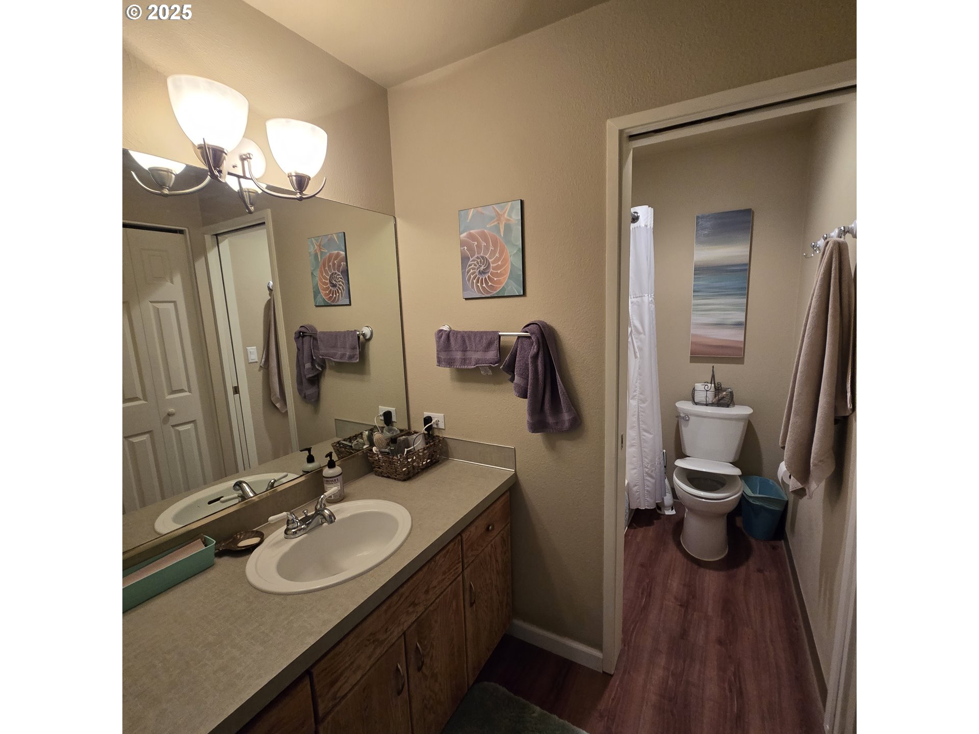 1000 Southeast Bay Blvd. Boulevard, Unit 124 Newport, OR 97365 - Photo 12 of 22 a bathroom with a sink a toilet and a mirror
