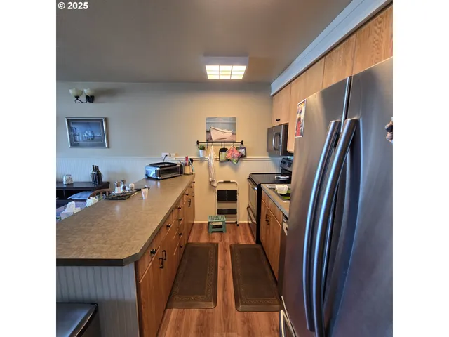a living room with lots of furniture and kitchen view