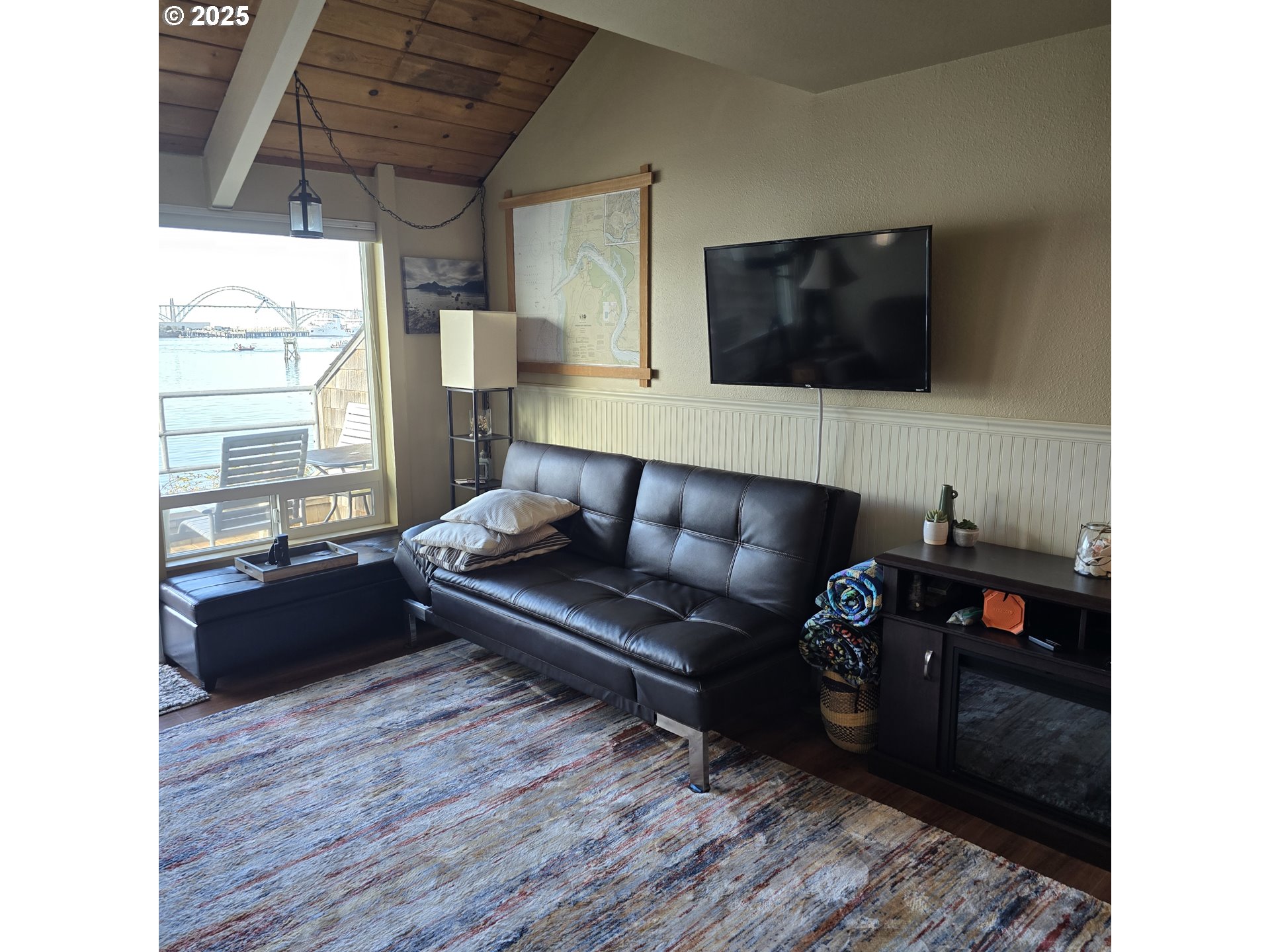 1000 Southeast Bay Blvd. Boulevard, Unit 124 Newport, OR 97365 - Photo 7 of 22 a living room with furniture and a flat screen tv