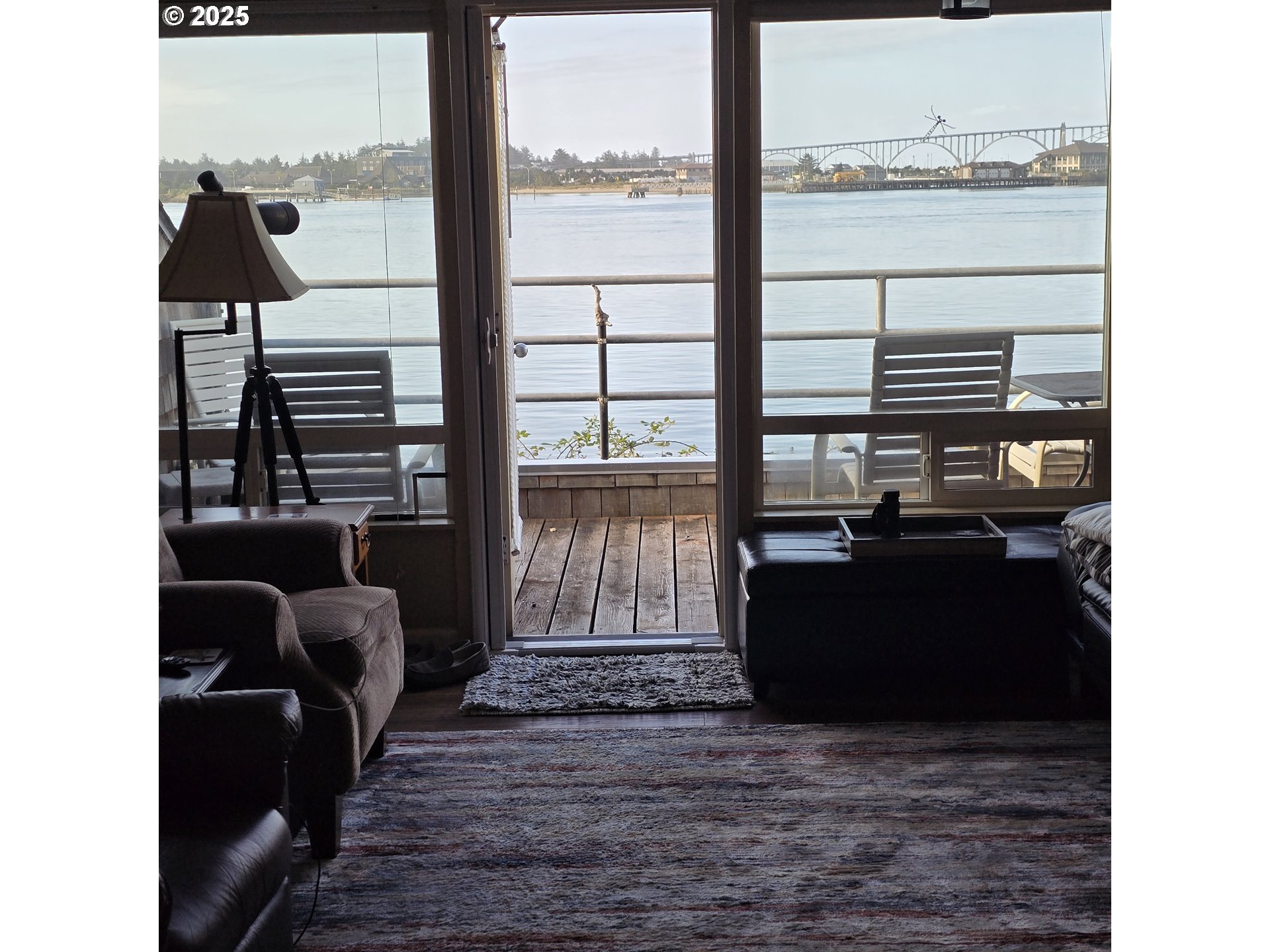 1000 Southeast Bay Blvd. Boulevard, Unit 124 Newport, OR 97365 - Photo 8 of 22 a living room with a floor to ceiling window and a wooden floor