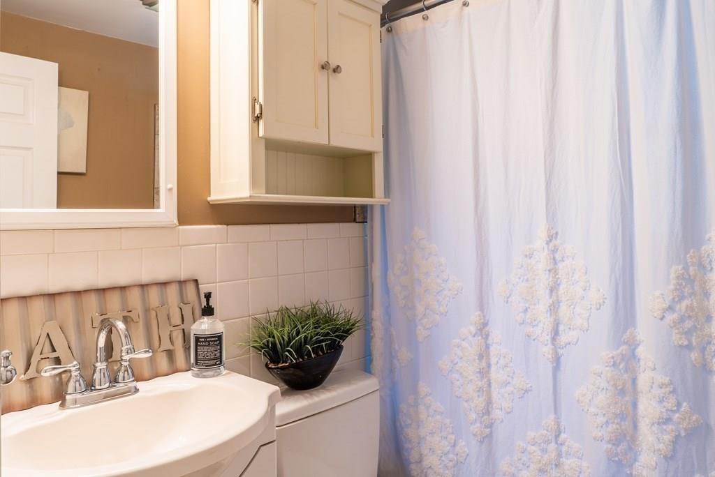 70 Brae Road Weymouth, MA 02191 - Photo 11 of 16 a bathroom with a sink and a mirror