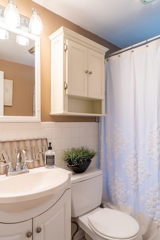 70 Brae Road Weymouth, MA 02191 - Photo 12 of 16 a bathroom with a sink toilet and shower