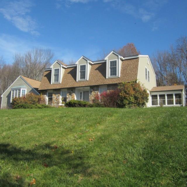 16 Apple Ridge Roxbury, CT 06783 - Photo 1 of 1 a front view of a house with a yard and trees