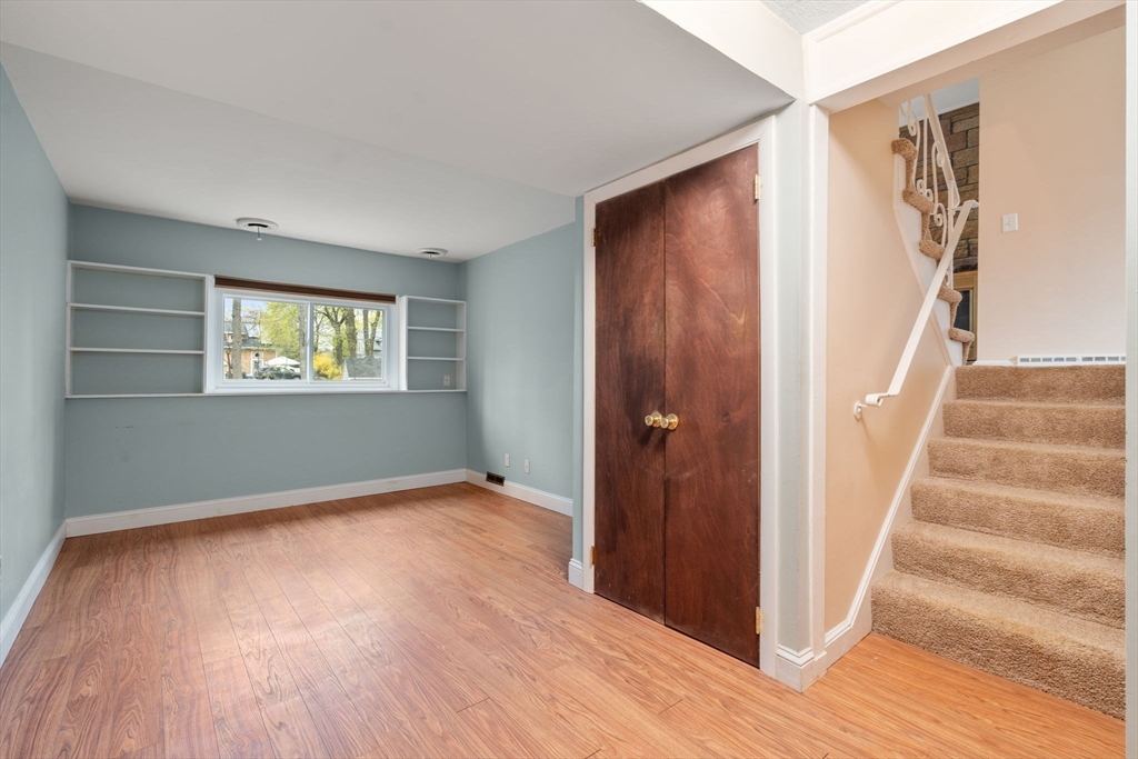 18 Royce Road Framingham, MA 01701 - Photo 18 of 30 a view of an empty room with wooden floor and stairs