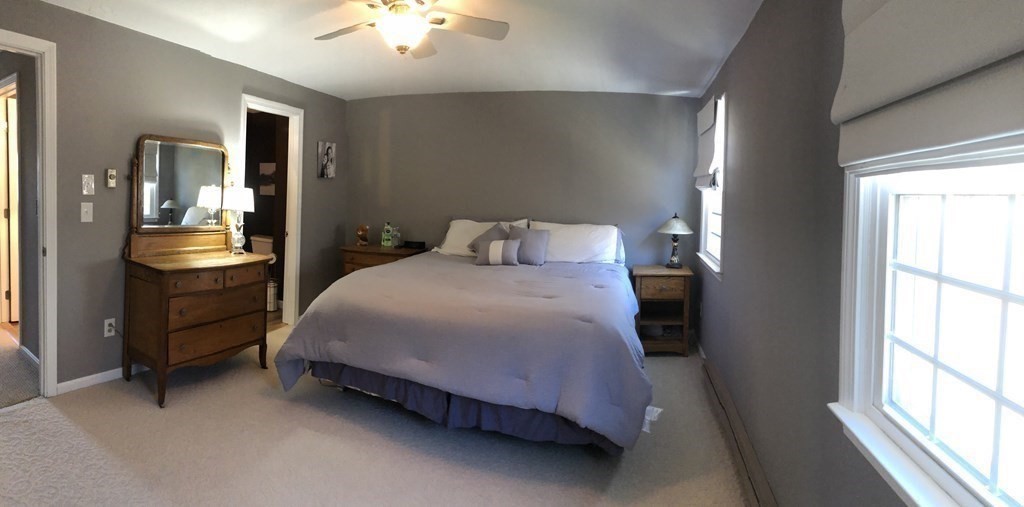 36 Atkins Road, Unit B5 Sandwich, MA 02537 - Photo 11 of 23 a bedroom with a bed and a chandelier